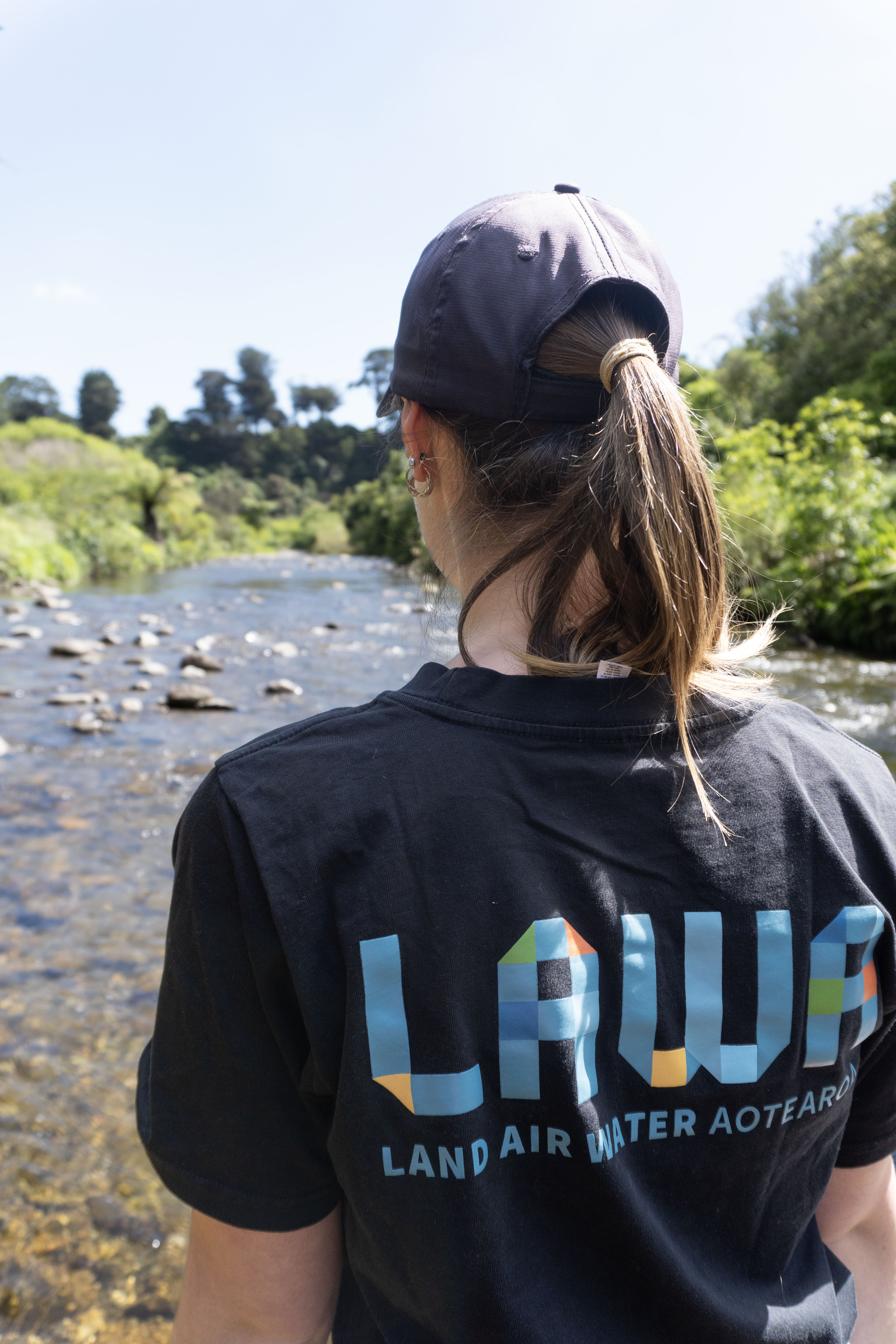 Horizons staff member wearing a LAWA branded t-shirt looking upstream